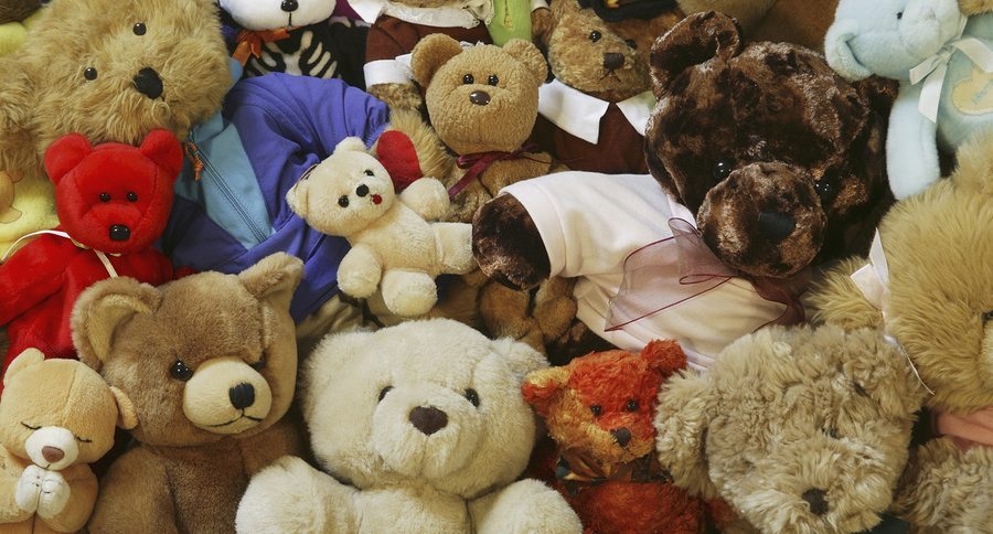 teddy bears laying in a pile in a child's room